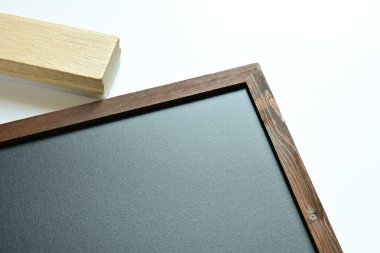 blank clean new chalkboard in wooden frame with eraser brush isolated on white background, blackboard for education school