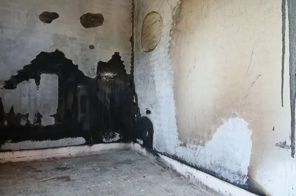 stock image old scary interior burn house, cement wall and wood floor