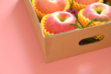 beautiful apple in the box on pink backgrond, healthy fruit