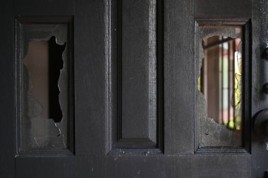 burn dirty black wood door with broken glass texture background