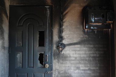 old burn black door and wall in house, scary texture background