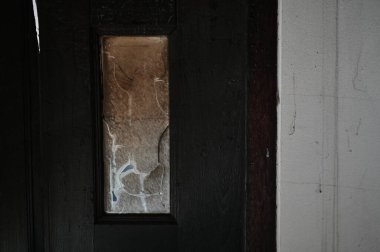 burn dirty black wood door with broken glass texture background