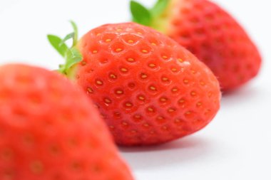 beautiful three fresh red strawberry isolated on white background