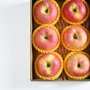 beautiful pink apple in the box on white background