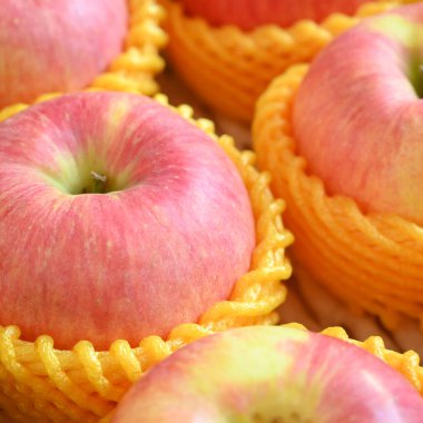 beautiful pink apple in yellow wrap bubble, healthy fruit in the box