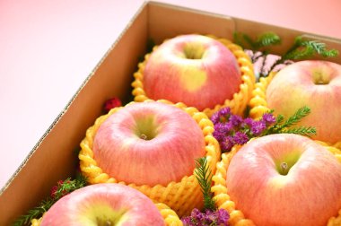 beautiful apple in the box on pink backgrond, healthy fruit