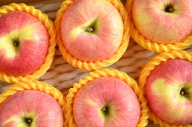 beautiful pink apple in yellow wrap bubble, healthy fruit in the box