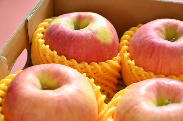 stock image beautiful pink apple in yellow wrap bubble, healthy fruit in the box