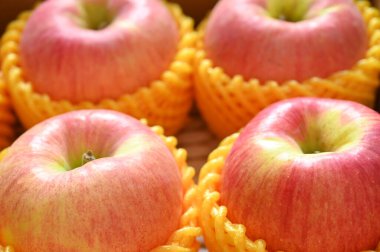 beautiful pink apple in yellow wrap bubble, healthy fruit in the box