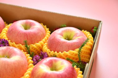 beautiful apple in the box on pink backgrond, healthy fruit