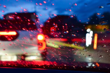 Gecenin bir yarısı kaza yapan arabanın ışığı yağmurlu bir günde arka planda bulanıklık.