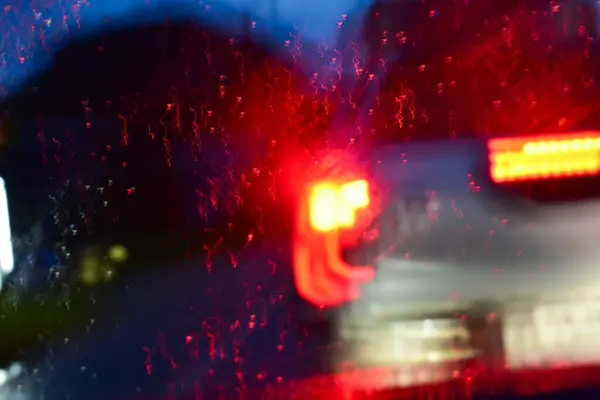 light of car on road with accident in the night, blurred background in rainy day