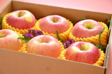 beautiful apple in the box on pink backgrond, healthy fruit