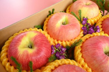 beautiful apple in the box on pink backgrond, healthy fruit