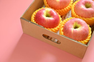 beautiful pink apple in the box on pink background