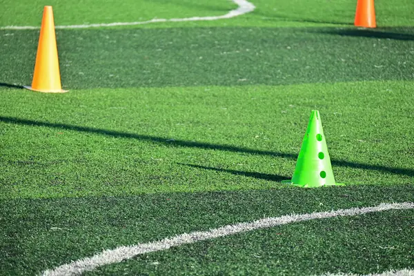 stock image artificial green grass soccer field with training cones