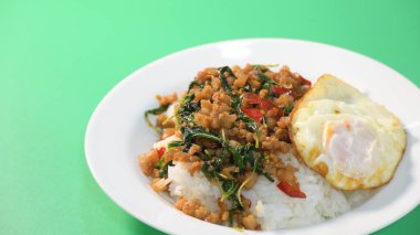 stir fried pork with holy basil on top with fried egg on cooked rice clipart