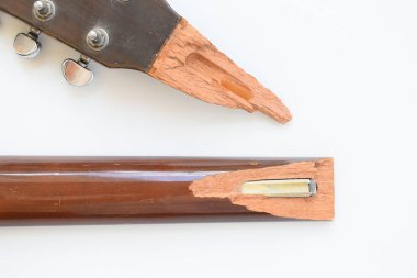 Kırık ahşap akustik gitarın beyaz arka planda izole edilmiş parçası