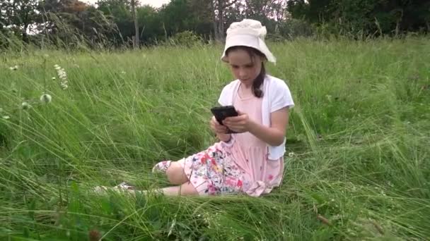 Girl Sits Field Looks Her Smartphone — Stock Video