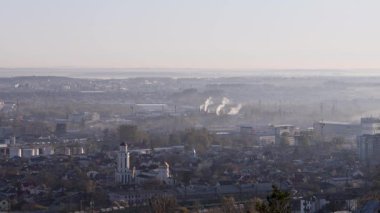 Sabah ışığında Lviv 'in sanayi bölgesinin panoramik görüntüsü, fabrikalar, bacalar, depolar ve demiryolları yumuşak bir gökyüzü altında uzanan, kentsel yapıyı...
