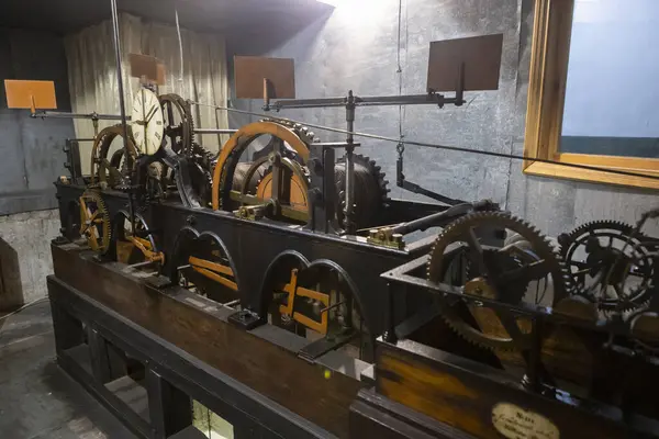 Antika bir kule saatinin karmaşık mekanizması, vites, dişli, dişli ve levyeli eski bir dönemin zanaatkarlığını ve mühendisliğini klasik bir cazibe ve zamansız hassasiyetle yakalıyor..