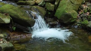 Taşların arasında bir dağ nehrinde şelale