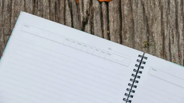 stock image White notebook paper on the grass with copy space                              