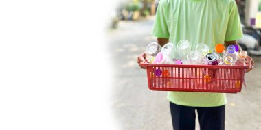 Boş plastik şişeleri içeren kırmızı plastik sepeti tutan ellerin yanında alanı kopyala, çevreyi kurtarmak için geri dönüşüm konsepti olarak kullan, yumuşak ve seçici odak