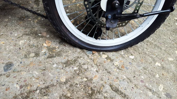 Black flat new bicycle tire on concrete ground
