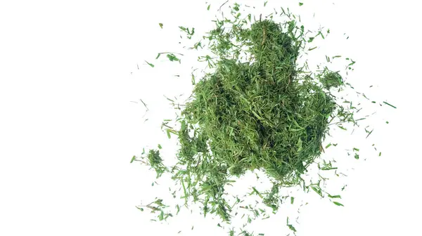 stock image Cut out grass clippings from a lawnmower, set against a white background, with clipping paths to capture the texture and fragments for seamless integration into design projects.