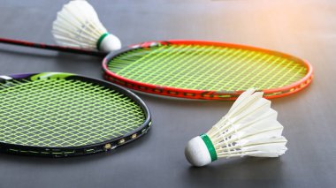 Karanlık arka planda raketleri olan Badminton mekikleri spor ve küresel rekabetin ruhunu, atletizmin özünü ve sporda mükemmelliği simgeliyor..