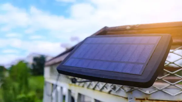 Close up small solar panel designed to power decorative lights along a balcony. The image highlights the compact solar cells, showcasing their functionality eco-friendly energy use.