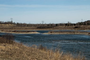 Low spring water level along the shore line. Dickson Dam Provincial Recreation Area, Red Deer County, Alberta, Canada