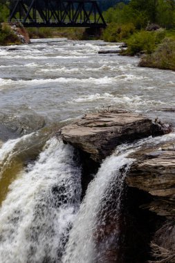 Water thunders over the falls in early spring. Lundbreck Falls PRA, Alberta, Canada