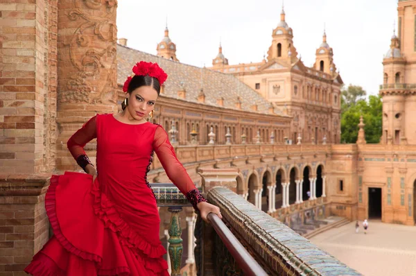 Sevilla 'da bir meydanın balkonunda flamenko yapan güzel bir genç kadın. Kırmızı bir elbise giyiyor ve bir sürü sanat eseri var. İnsanlığın Flamenko kültürel mirası.