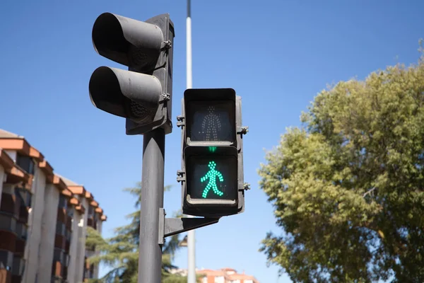 Traffic lights with green light illuminated.