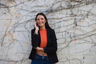 young beautiful woman leaning on a wall makes different expressions, sad, melancholic, happy, exhausted, dazed, smiling, thinking, tired. Concept different expressions.