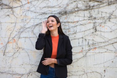 young beautiful woman leaning on a wall makes different expressions, sad, melancholic, happy, exhausted, dazed, smiling, thinking, tired. Concept different expressions.