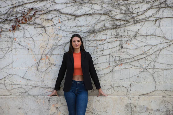 young beautiful woman leaning on a wall makes different expressions, sad, melancholic, happy, exhausted, dazed, smiling, thinking, tired. Concept different expressions.