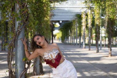 Latin kadın, genç ve güzel dans eden modern dans parktaki sokakta ve farklı ifadeler ve duruşlar sergiliyor. Konsept dansı, hip hop, dans, sanat, aksiyon, güzellik, gençlik sanatı.