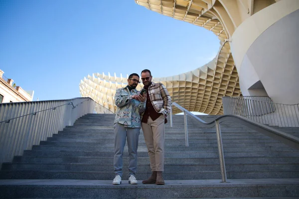 Young Couple Gay Men Checking Mobile Phone While Standing Stairs — 스톡 사진