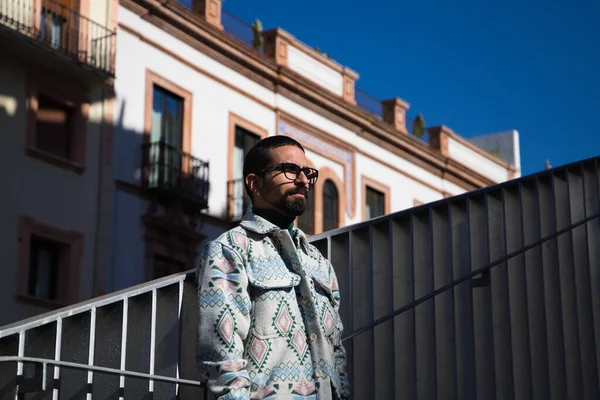 stock image Portrait of young handsome gay man with beard and glasses. The man is dressed casually and in modern clothes and is serious and angry.