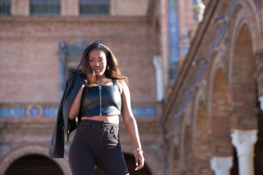 Genç ve güzel siyah Latin kadın Seville şehrinin en önemli meydanını ziyaret ediyor. Kadın uluslararası moda etkinliklerinin yapıldığı meydanın merdivenlerinden iniyor..