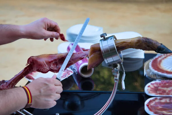 Stock image Ham slicer. Detail of the hand cutting slices of Spanish Iberian ham.