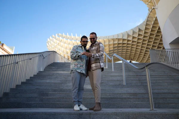 Young Couple Gay Men Checking Mobile Phone While Standing Stairs — ストック写真