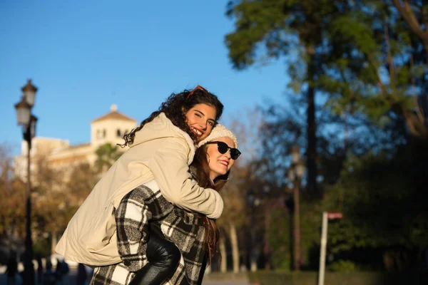 Two Young Beautiful Spanish Women Who Friends Have Fun Playing — Stockfoto