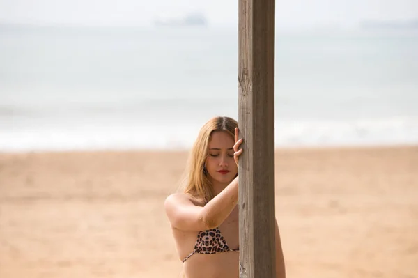 Ganska Ung Blond Kvinna Lutar Sig Mot Träaffischen Badvaktstornet Stranden — Stockfoto