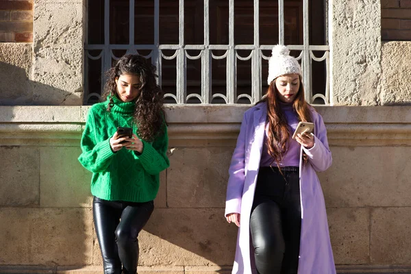 Two Young Beautiful Spanish Women Consulting Mobile Phone Street Big — Stockfoto
