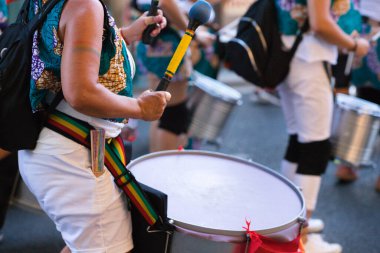 Eşcinsel gururu yürüyüşündeki bir grup yürüyüşçü senkronize bir şekilde davul çalıyor. Kutlama, eşitlik, gey ve insan hakları günü.