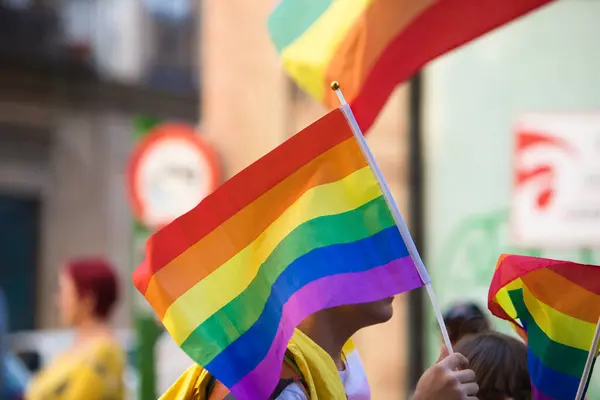 Gay rainbow flag during the demonstration for gay and LGBTQ rights in the city of Seville, Spain. Concept of equality and gay rights